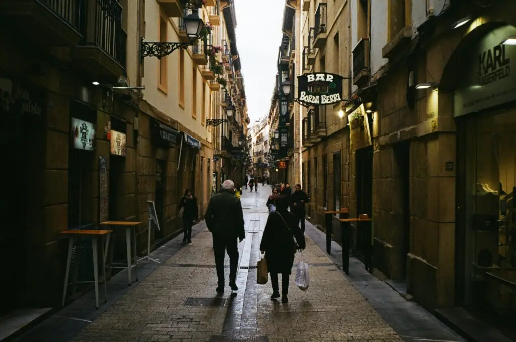 a couple of people that are walking down a street